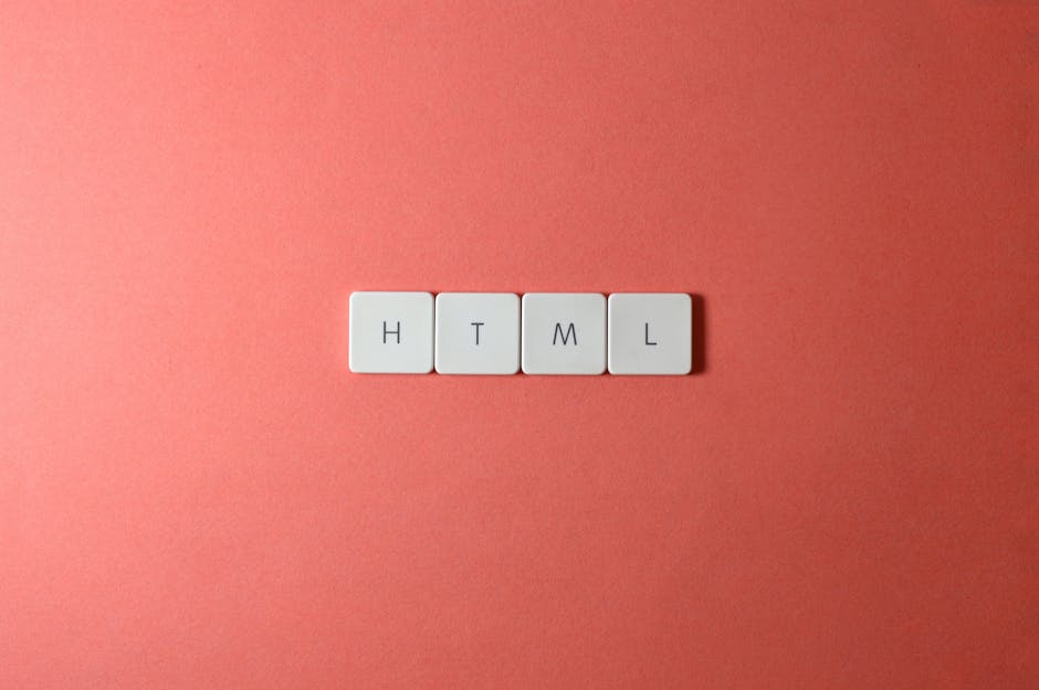 A close-up of four white tiles arranged in a horizontal row on a pink background, each tile featuring a black letter spelling out 'HTML', representing coding language. The surface of the tiles is smoo